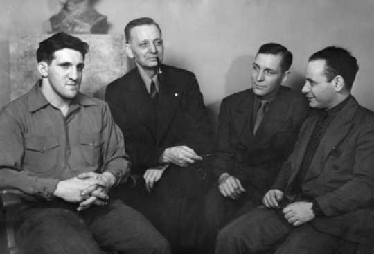 Black and white photograph of Jake Cooper, Oscar Coover, Harry DeBoer, and Max Geldman at the Minneapolis Headquarters during the time of their trial, 1941.