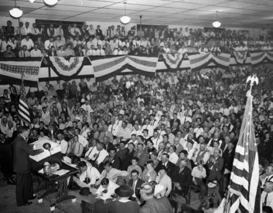 Black and white photograph of Governor Elmer Benson speaking at a Farmer-Labor state convention in Duluth, 1938.