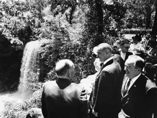 Black and white photograph of President Lyndon Johnson, Senator Hubert Humphrey, Governor Karl Rolvaag and party at Minnehaha Falls.