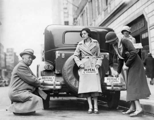 Black and white photograph of people with bumper stickers advocate the repeal of the 18th Amendment (Prohibition), 1932.
