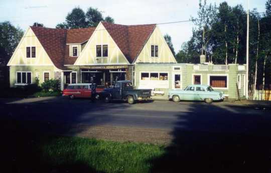 Color image of Lamb’s Resort, ca. 1957, after the inn was connected to old gas station, facing south. 