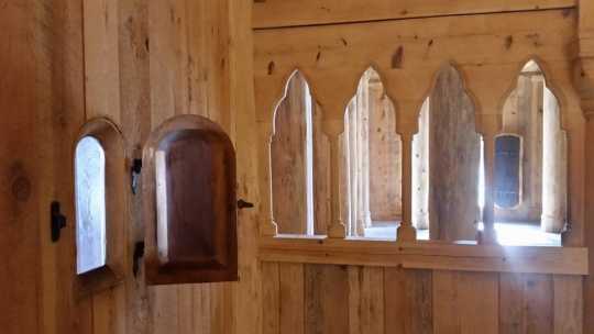 Color image of the leper’s window and part of the choir screen separating the chancel from the nave inside the Hopperstad Stave Church replica, April 2, 2017. Photographed by Kaci Johnson.