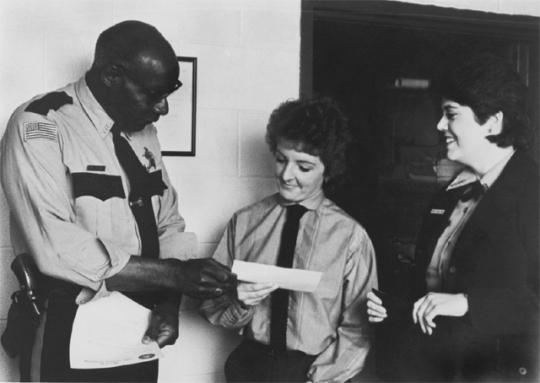 Photograph of John Lyght presenting a scholarship check