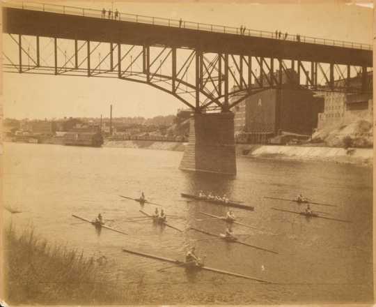 The Minnesota Boat Club racing on the Mississippi River, St. Paul, ca. 1890.