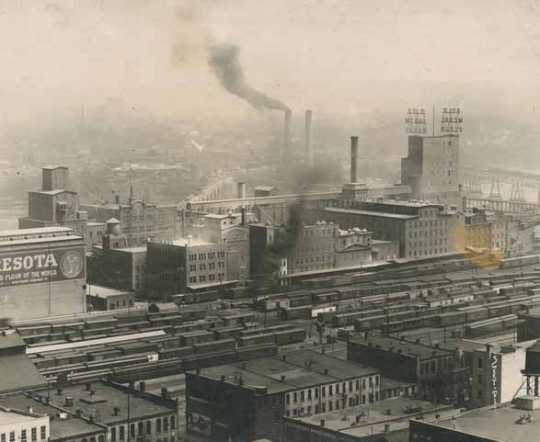 Black and white photograph of the the West Side Milling District of Minneapolis from the courthouse showing the extensive rail yards required for the shipping of grain and flour, ca. 1912. Photograph by Sweet.