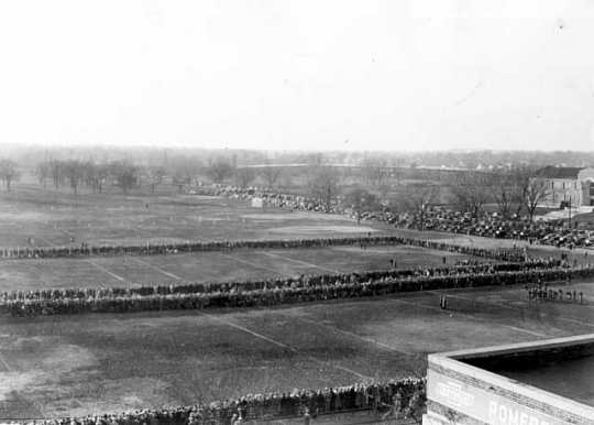Black and white photograph of fans lining the fields for football games at The Parade, about 1923.