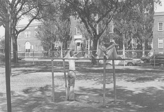 Black and white photograph of children in front of the Northeast Neighborhood House, 1976.