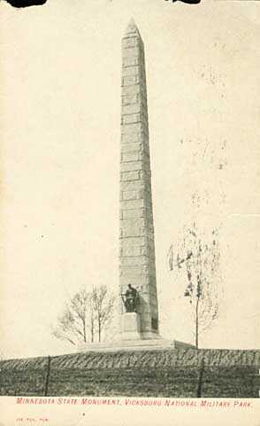 Photograph of an obelisk with a statue of a soldier at its base.