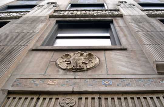 Color image of an eagle medallion and tile work above the main entrance of the Minnesota Building, 2009.