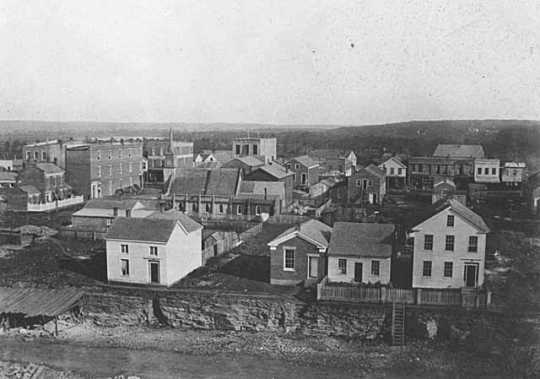 Photograph taken by Benjamin Franklin Upton from the steeple of the Ramsey County Courthouse in St. Paul, 1857. The Day and Jenks drug store appears in the middle-left of the image.