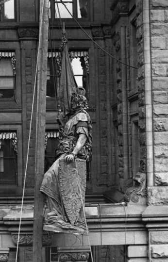 Black and white photograph of the statue of Germania being removed from the Germania Building, St. Paul, 1918.