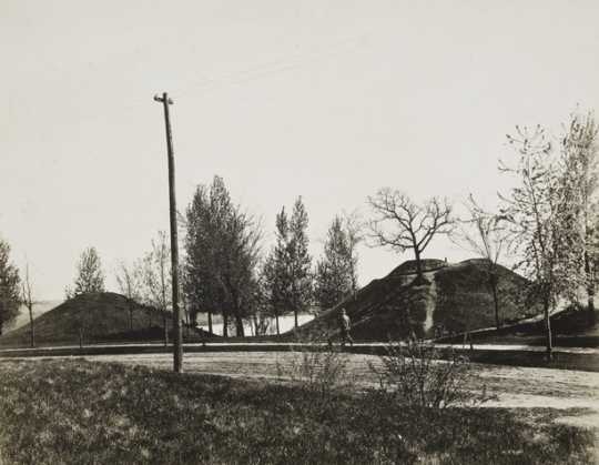 Black and white photograph of two of the mounds, with walking path, at Indian Mounds Park, ca. 1900. 
