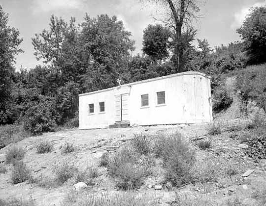 Black and white photograph of boxcar chapel in Swede Hollow, 1949.