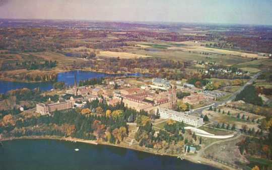 Aerial color photograph of Saint John's Abbey and University in Collegeville. Created by Henry Anderl c.1960.