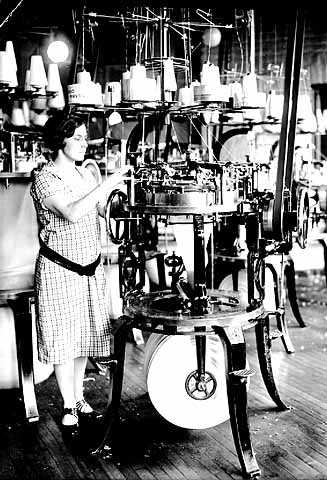 photograph of a woman operating a Munsingwear knitting machine