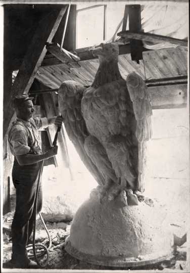 Man working on the eagle at the top of the capitol