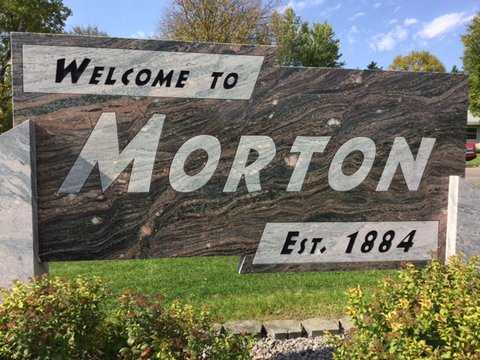 Color image of a sign welcoming visitors to the city of Morton, 2016. The sign is made out of Morton gneiss. Photograph by Paul Nelson.