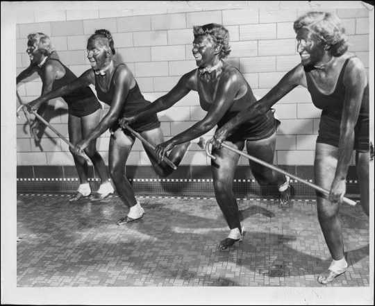 University of Minnesota students, and members of the campus Aquatic League, practice a dance number in blackface for the comic water ballet to be performed in the Cooke Hall exhibition pool on Friday night. L to R: Susan Fredrickson of Santa Cruz, California; Trudy Schlek of Milwaukee, Wisconsin; Kit Thiele of Madison, Minnesota; and Gerrie Ghent of St. Paul, rehearse a "Licorice Lindy" dance number with canes in Cooke Hall. Originally published in the Minneapolis Tribune, April 14, 1950. 