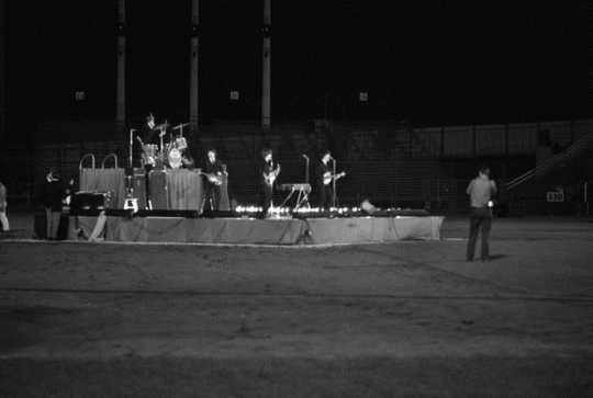 Black and white photograph of The Beatles in concert at Metropolitan Stadium, Bloomington, August 21, 1965. Photograph: Neale, St. Paul Dispatch & Pioneer Press.