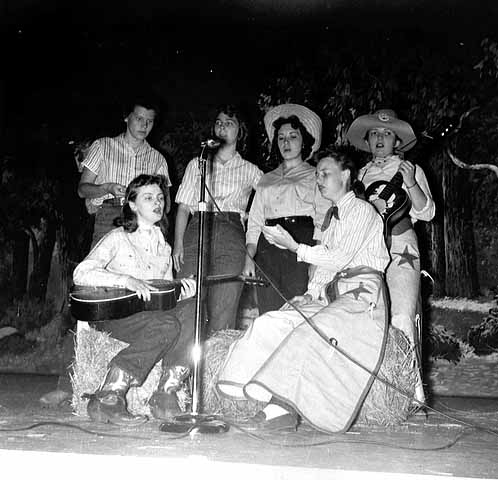 Black and white photograph of student nurses putting on a musical program for patients at Rochester State Hospital, 1958.