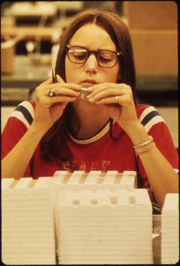 3M employee at work in New Ulm, 1974. 3M had (and has, as of 2019) a factory in New Ulm that built electrical parts. Public domain.