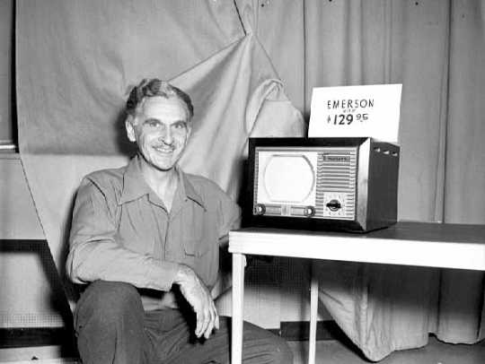 Black and white photograph of a WTCN-TV employee with an Emerson television set, 1949.