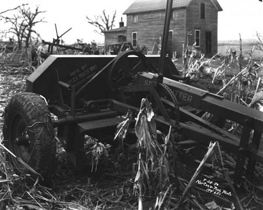 Corn stalk cutter in field. Photograph by Norton & Peel, April 28, 1950.