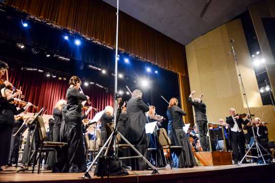 Color image of the Minnesota Orchestra performing the Cuban National Anthem at the Teatro Nacional in Havana. 2015.