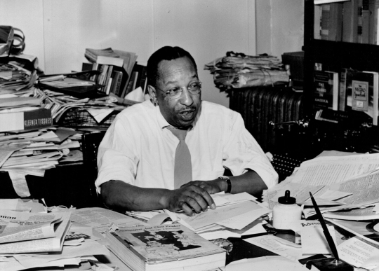 Cecil Newman at his desk