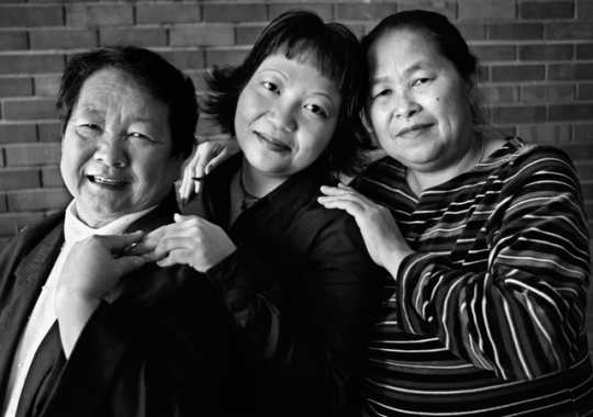 Black and white photograph of three generations of Hmong women (Mao Thao Yang, Mai Vang Thao, and Bo Thao), 1999.