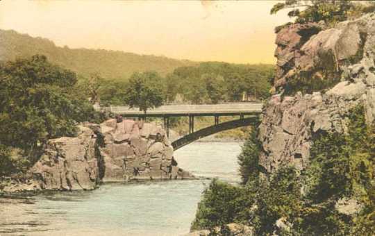 Colorized post card view of Old Man of the Dalles of the St. Croix and bridge over the river, 1920. 