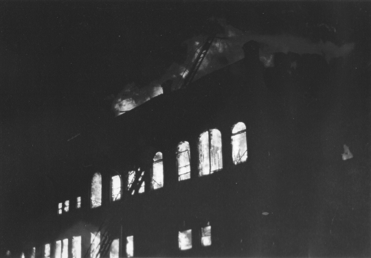 Flames from the 1987 Opera House Block fire light up the night and smoke is seen up to ten miles away.