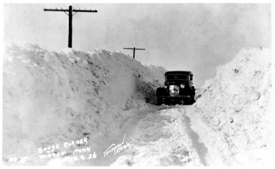 Car driving through a snowbank