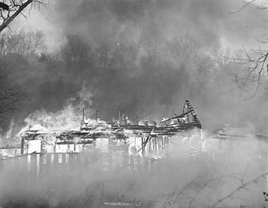 Black and white photograph of the burning of Swede Hollow, St. Paul, 1956.