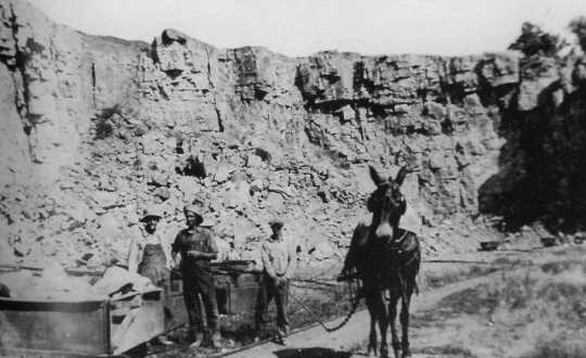 Black and white photograph of workers and a mule at a quarry in what now is Blue Mounds State Park, ca. 1880s.