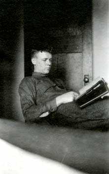 Black and white photograph of Charles Augustus Lindbergh and his photo album, Madison, Wisconsin, March, 1922.