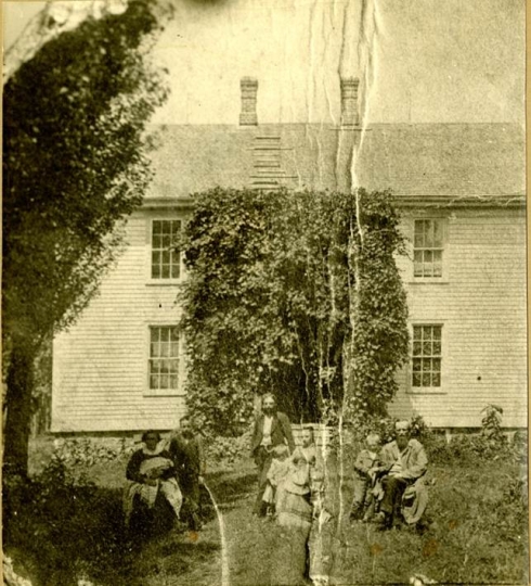 Black and white photograph of the Reverend Bernt J. Muus and family outside of Holden Parsonage in Kenyon, c.1875.