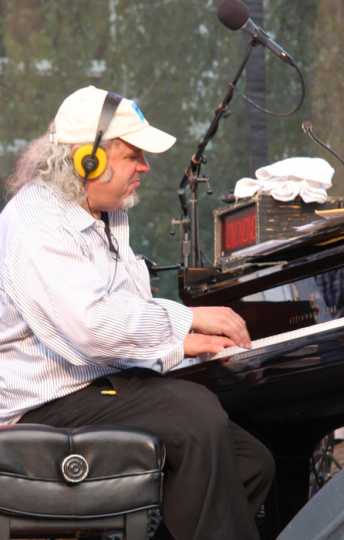 Longtime house pianist and music director Richard Dworsky plays during a live broadcast of A Prairie Home Companion at Macalester College in St. Paul, July 2015. Photograph by Wikimedia Commons user Jonathunder.