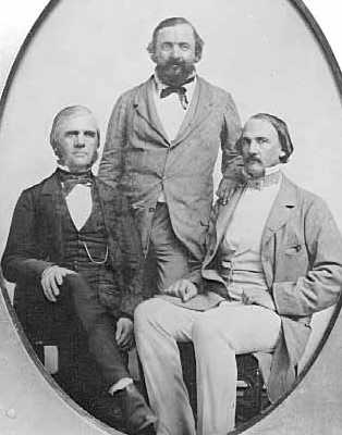 Black and white photograph of Rolette (standing) with business associates Henry Hastings Sibley (right), and possibly Franklin Steele (left), c.1857.