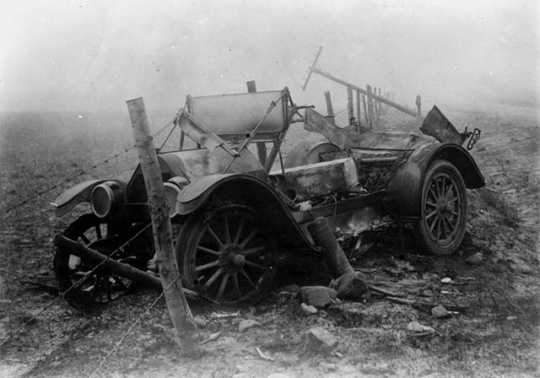 Black and white photograph of the ruins of a car after fire, Kettle River Road, 1918. 