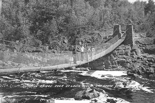 Black and white photograph of the 1939 swinging bridge over St. Louis River, Jay Cooke State Park, ca. 1950.