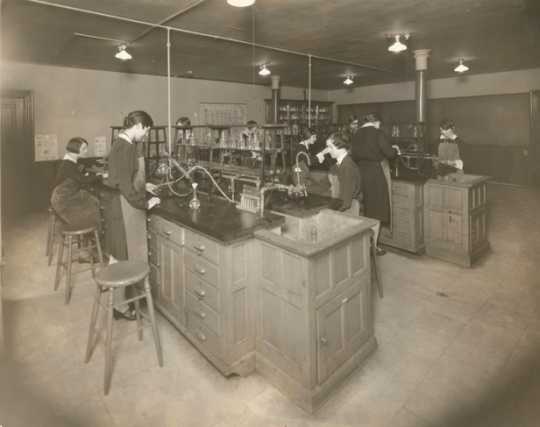Black and white photograph of students at St. Joseph’s Academy performing experiments in the school’s chemistry lab, c.1930s.