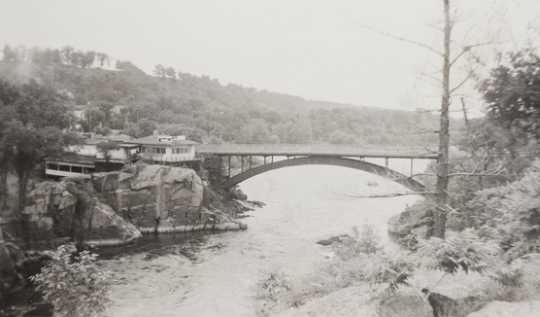 Black and white photograph of St. Croix River, Dalles of the St. Croix. Includes view of Showboat Inn and Interstate Bridge, 1905–1949.