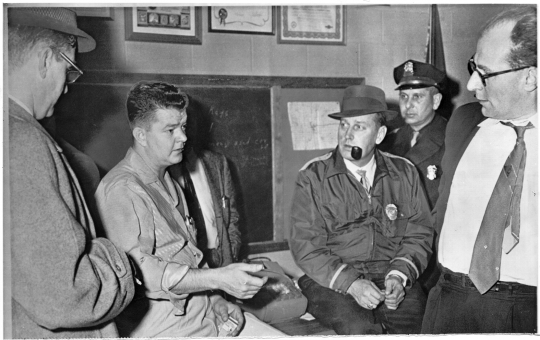 The president of the United Packing House Workers of America (UPWA) union Local 6, Charles Lee (second from left), with Freeborn County attorney O. Russell Olson (far left), sheriff Everette Stovern (third from right), police lieutenant Woodrow Chrz (second from right), and union lawyer Doug Hall (far right), 1959. Minneapolis Star Tribune portraits collection (news photos, box 108), Minnesota Historical Society.