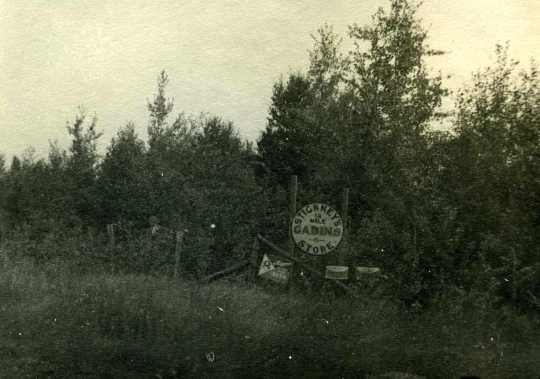Black and white photograph of a sign on Highway 61 marking “Stickney’s Cabins & Store,” ca. 1940. 