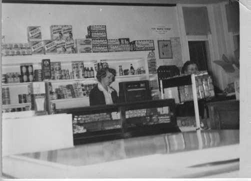Black and white photograph of the interior of Stickney’s grocery store, ca. 1950. 