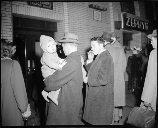Passengers waiting to board a train in the concourse of the St. Paul Union Depot.