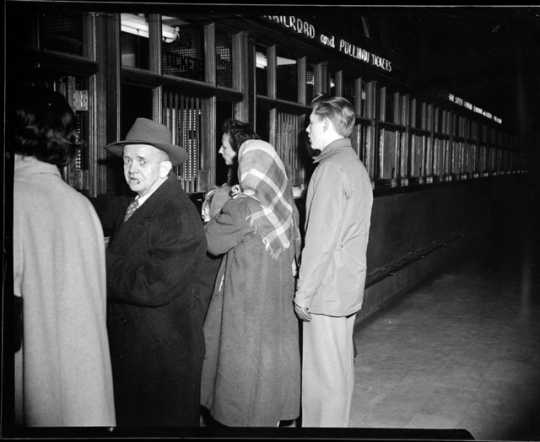 Passengers purchase train tickets at the St. Paul Union Depot.