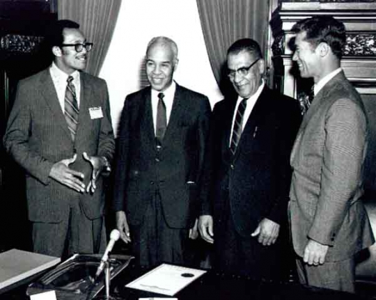 1975 Photograph of Roy Wilkins, Samuel Richardson, Governor Wendell Anderson and an unidentified man.