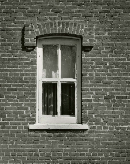 Black and white photograph of a window in the Arnold Nietfield house in Meire Grove.